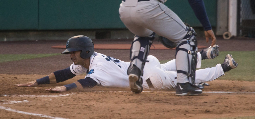Aquasox’s David Frick slides across home plate for a run as the Everett Aquasox beat the Tri-City Dust Devils in a home opening game at Funko Field on Tuesday, May 11, 2021 in Everett, Washington. (Andy Bronson / The Herald)
