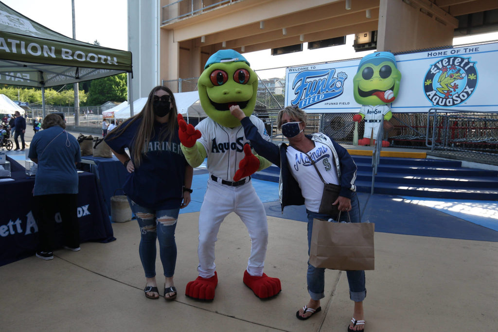Fans get photos with Webbly the mascot before the Everett Aquasox beat the Tri-City Dust Devils in a home opening game at Funko Field on Tuesday, May 11, 2021 in Everett, Washington. (Andy Bronson / The Herald)
