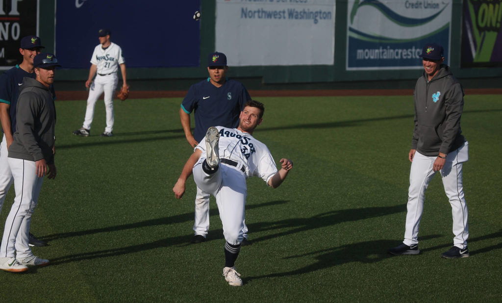Aquasox’s Brendan McGuigan kicks a wacky-sack to warm up with teammates before the game. The Everett Aquasox beat the Tri-City Dust Devils in a home opening game at Funko Field on Tuesday, May 11, 2021 in Everett, Washington. (Andy Bronson / The Herald)