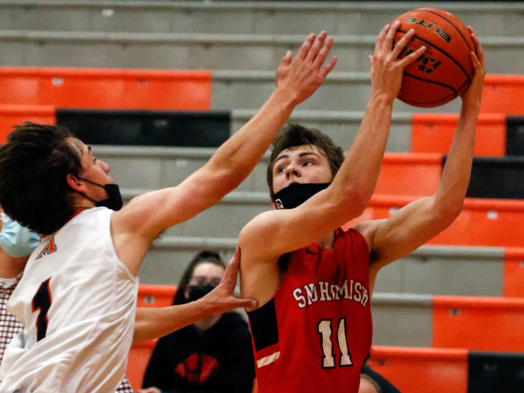 Snohomish’s Wes Ostlund (right) catched a pass with Monroe’s Steve Kuhnle defending during a game on May 11, 2021, at Monroe High School. The Bearcats won 36-35. (Kevin Clark / The Herald)
