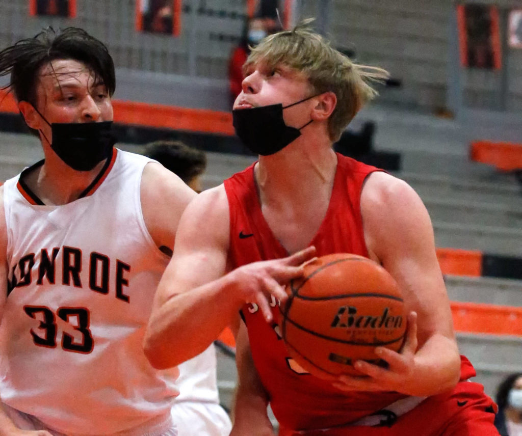 Snohomish’s Grady Kentch controls the ball Monroe’s Ryan Lynch defending during a game on May 11, 2021, at Monroe High School. The Bearcats won 36-35. (Kevin Clark / The Herald)
