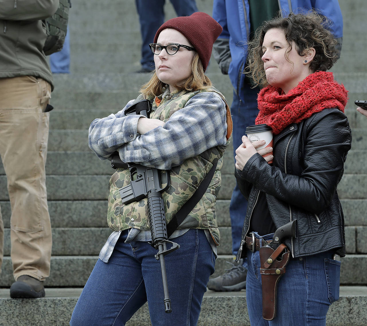 Erin Volz (left) and Andrea Snoke carry weapons during a 2019 gun-rights rally at the Capitol in Olympia. (AP Photo/Ted S. Warren, file)