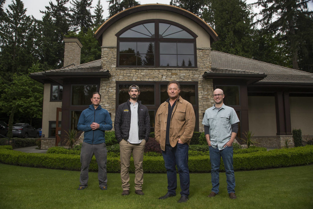 Assistant winemakers Hal Iverson, left, and Jeff Schmidt with Paul Golitzin, president and director of winemaking, with winemaker Alex Stewart, right, at Quilceda Creek on Monday, May 17, 2021 in Snohomish, Washington. (Andy Bronson / The Herald)
