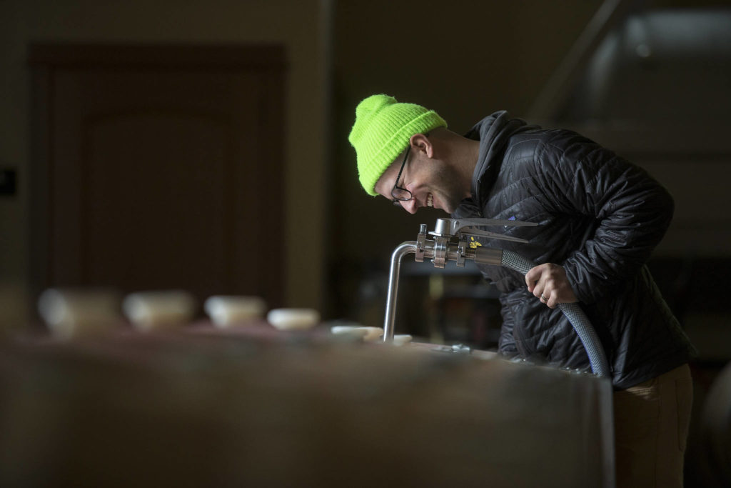 Winemaker Alex Stewart fills barrels with Columbia Valley Red at Quilceda Creek on Monday, May 17, 2021 in Snohomish, Washington. (Andy Bronson / The Herald)
