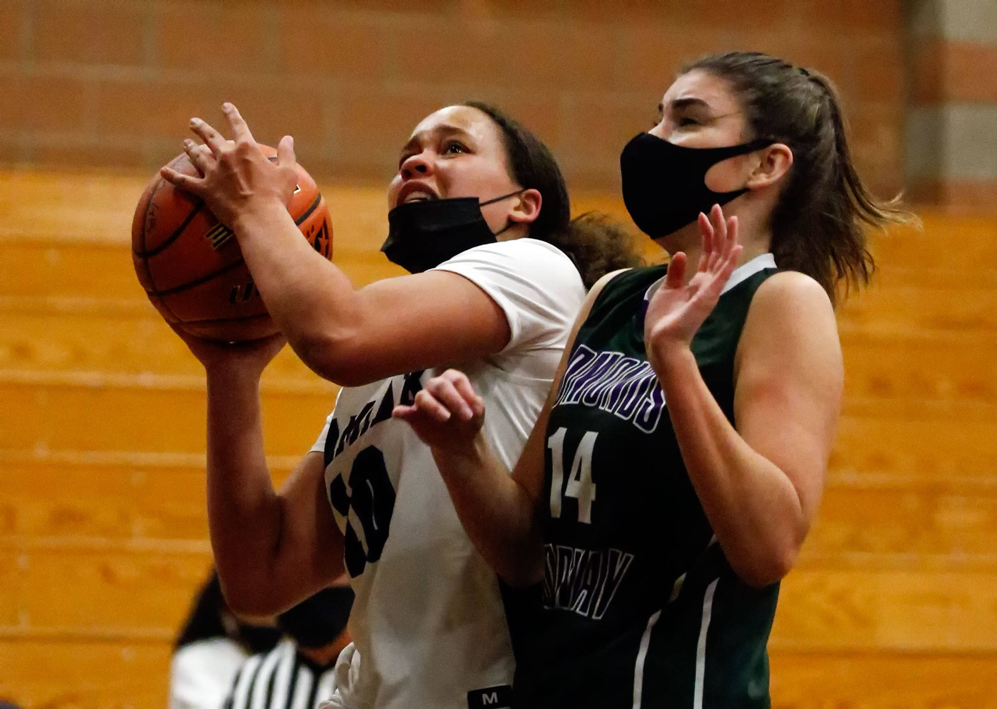 Kamiak’s Nayella George (left) drives the lane with Edmonds-Woodway’s Melanie Walsh defending during a game on May 14, 2021, at Kamiak High School in Mukilteo. (Kevin Clark / The Herald)