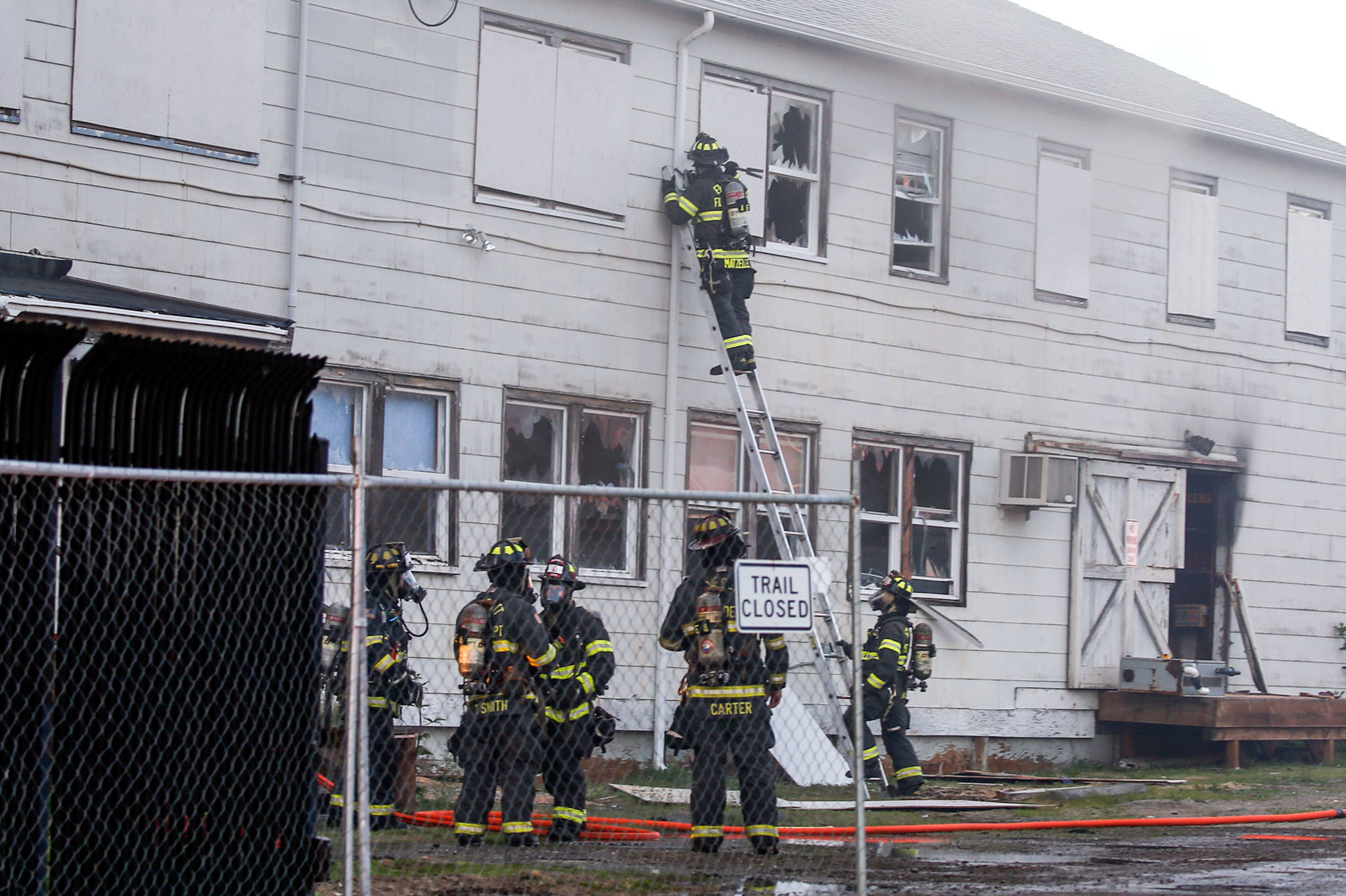 Firefighter douse the flames at the NOAA Fisheries Building Friday evening in Mukilteo. (Kevin Clark / The Herald)