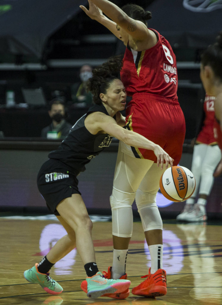 Seattle Storm’s Sue Bird is fouled by Las Vegas Aces’ Liz Cambage during a game on May 15, 2021, in Everett. (Olivia Vanni / The Herald)
