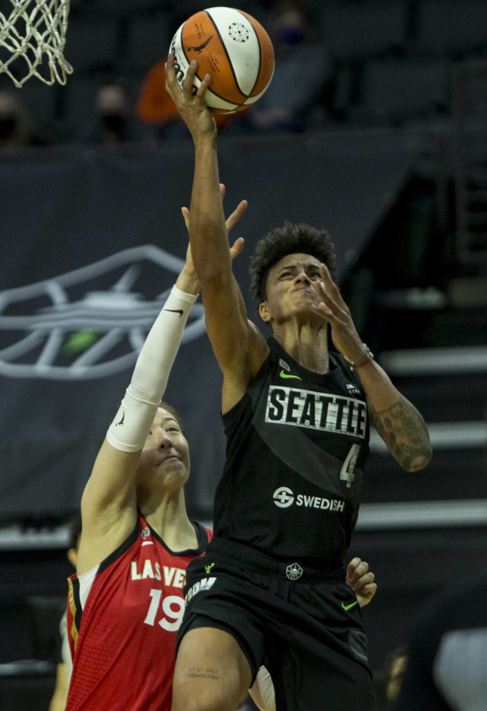 Seattle Storm’s Candice Dupree makes a layup past Las Vegas Aces’ JiSu Park during a game on May 15, 2021, in Everett. (Olivia Vanni / The Herald)
