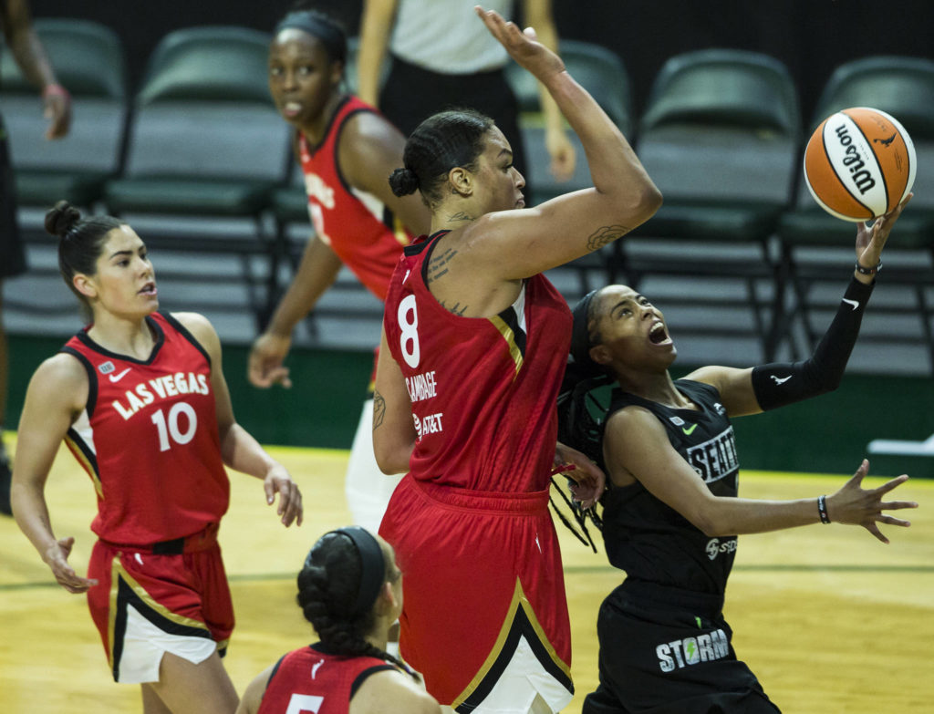 Seattle Storm’s Jordin Canada is fouled by Las Vegas Aces’ Liz Cambageas as she attempts a layup during a game on May 15, 2021, in Everett. (Olivia Vanni / The Herald)
