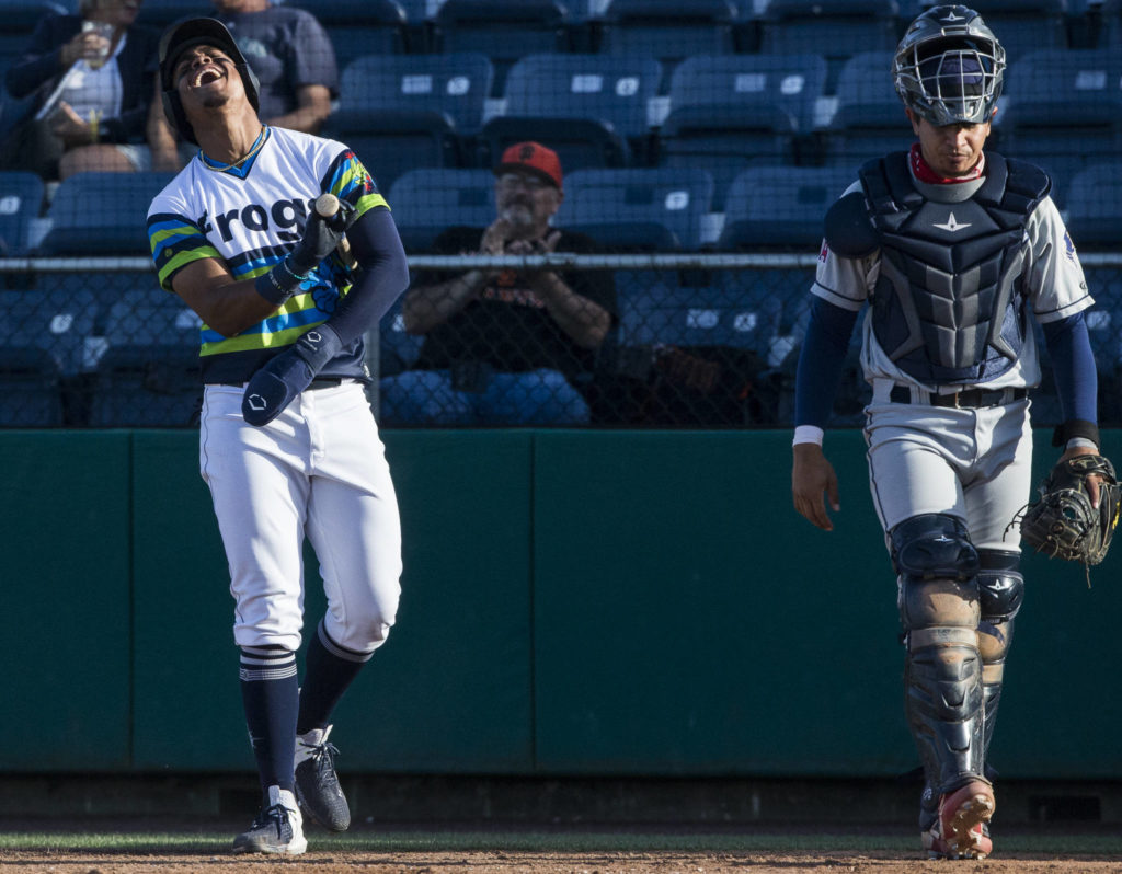 AquaSox’s Julio Rodriguez reacts to teammate Zach DeLoach’s grand slam during the game against the Dust Devils on Sunday, May 16, 2021 in Everett, Wash.
