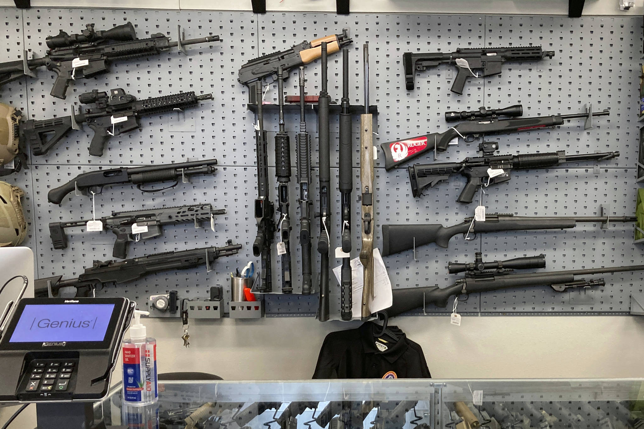 FILE - In this Feb. 19, 2021, file photo, firearms are displayed at a gun shop in Salem, Ore. The first legal test of whether a wave of U.S. counties can legally declare themselves "Second Amendment Sanctuaries," and refuse to enforce certain gun laws is playing out in a rural Oregon logging county. The measure Columbia County voters narrowly approved last year bans local officials from enforcing most federal and state gun laws, which includes things like universal background checks or any prohibition on carrying guns. (AP Photo/Andrew Selsky, File)