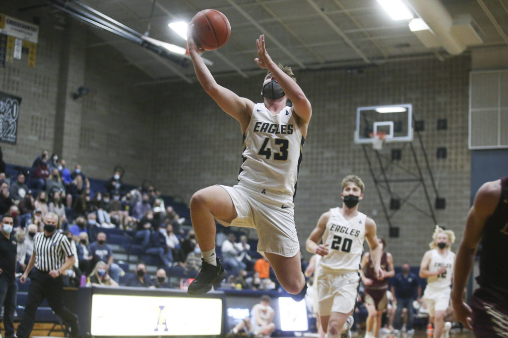 Arlington’s Ethan Martin makes a fast-break to the basket during a game against Lakewood on May 19, 2021, in Arlington. (Andy Bronson / The Herald)
