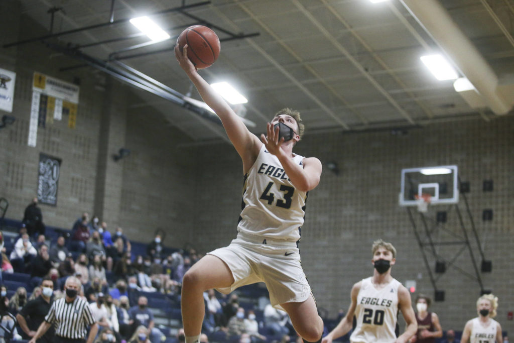 Arlington’s Ethan Martin makes a fast-break to the basket during a game against Lakewood on May 19, 2021, in Arlington. (Andy Bronson / The Herald)
