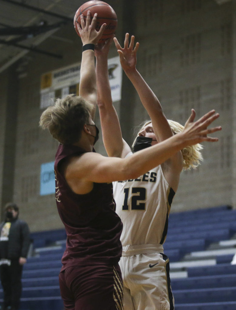 Lakewood’s Blake Conyers blocks a shot by Arlington’s Trent Nobach during a game on May 19, 2021, in Arlington. (Andy Bronson / The Herald)
