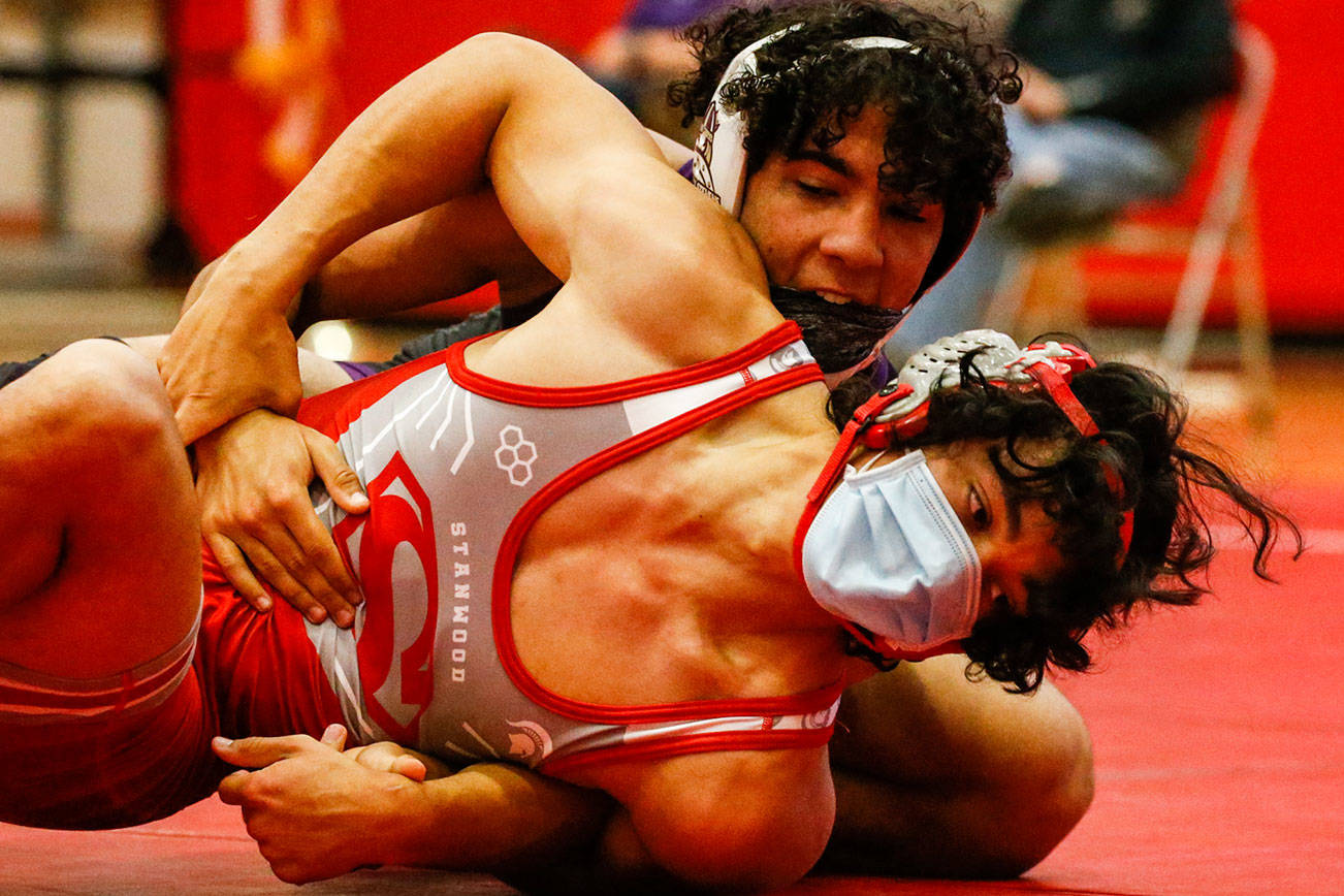 Lake Stevens' Jackson Balmer wrestles Stanwood's Preston Ing Thursday night at Stanwood High in Stanwood on May 20, 2021. Lake Stevens won the match against Stanwood 48-33.  (Kevin Clark / The Herald)