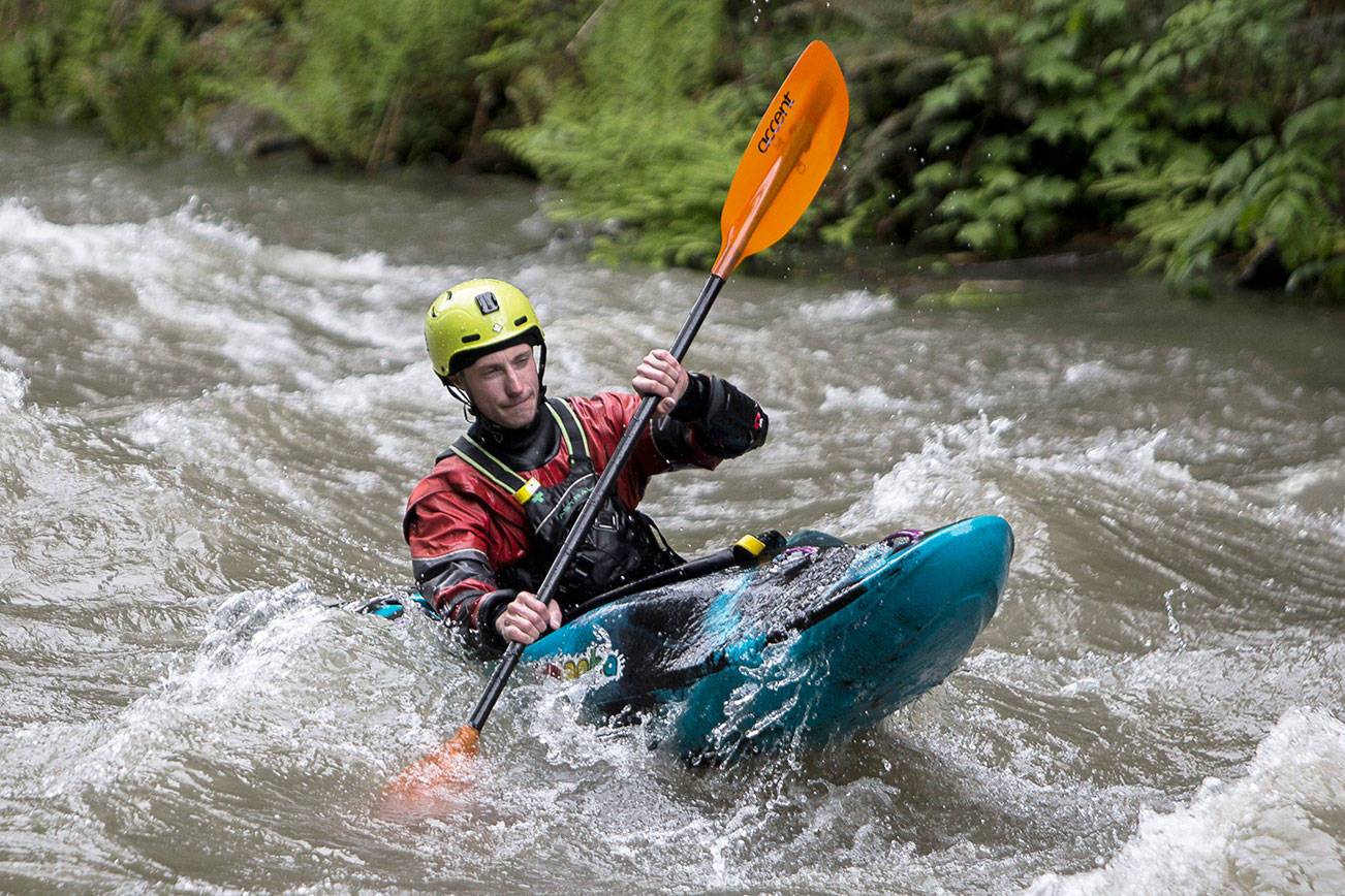 A kayaker paddles through rapids on the Sultan River on Saturday, May 22, 2021 in Sultan, Wash.