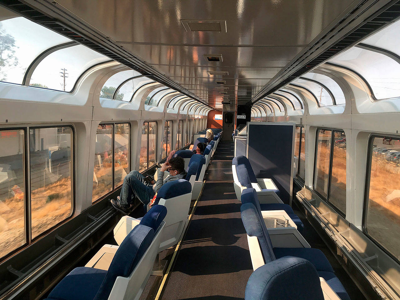 This 2017 photo shows passengers lounging in the observation car of Amtrak’s Coast Starlight on the way from Los Angeles to Seattle. (AP Photo/Nicole Evatt, file)