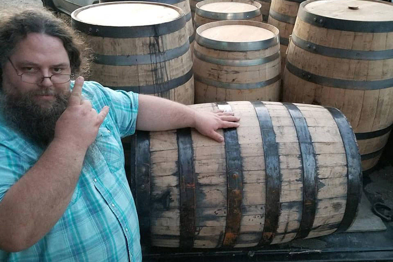 Hammered Dwarf owner and cider-maker John Flemming poses in front of a trailer full of barrels he recently purchased. Flemming is filling the barrels with cider to create a lineup of enticing barrel-aged ciders. (Hammered Dwarf Cider)