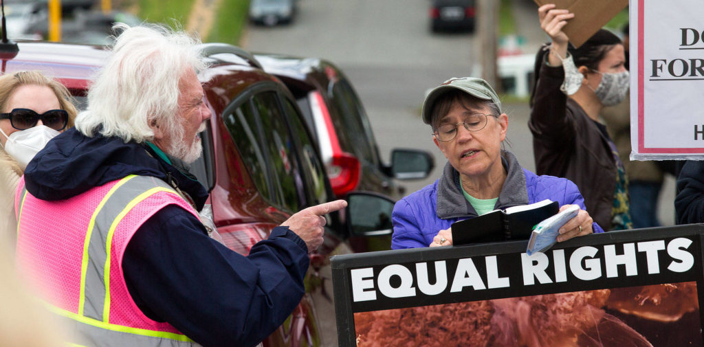 Pro-choice protester Rick Pollock confronts an anti-abortion protester, who goes by the name Patty, as they stand shoulder to shoulder Wednesday in front of the Planned Parenthood building on 32nd Street in Everett. (Andy Bronson / The Herald)
