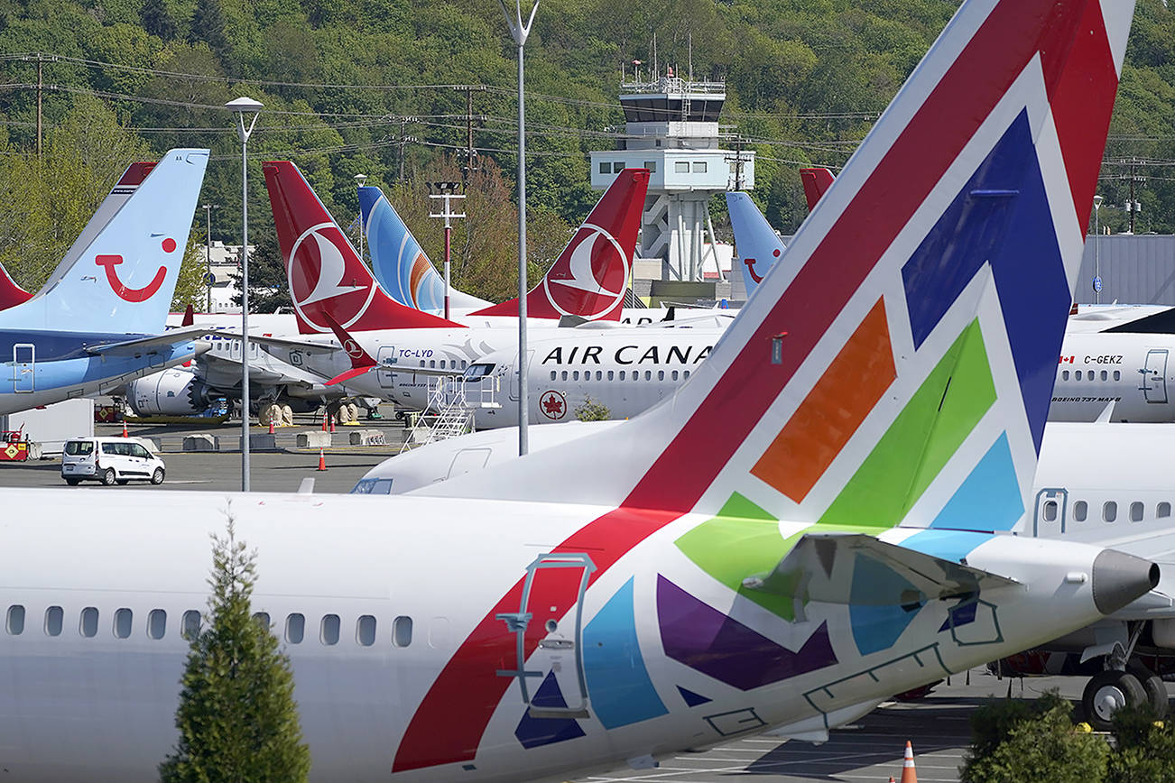 Boeing 737 Max airplanes sit parked in a storage lot, Monday, April 26, 2021, near Boeing Field in Seattle.  Boeing is paying $17 million and promising to take steps to fix production problems with its popular 737 jets. The Federal Aviation Administration said Thursday, May 27,  that the settlement covers the installation of unapproved sensors and other parts on some Boeing 737 models including NGs and the Max.   (AP Photo/Ted S. Warren)