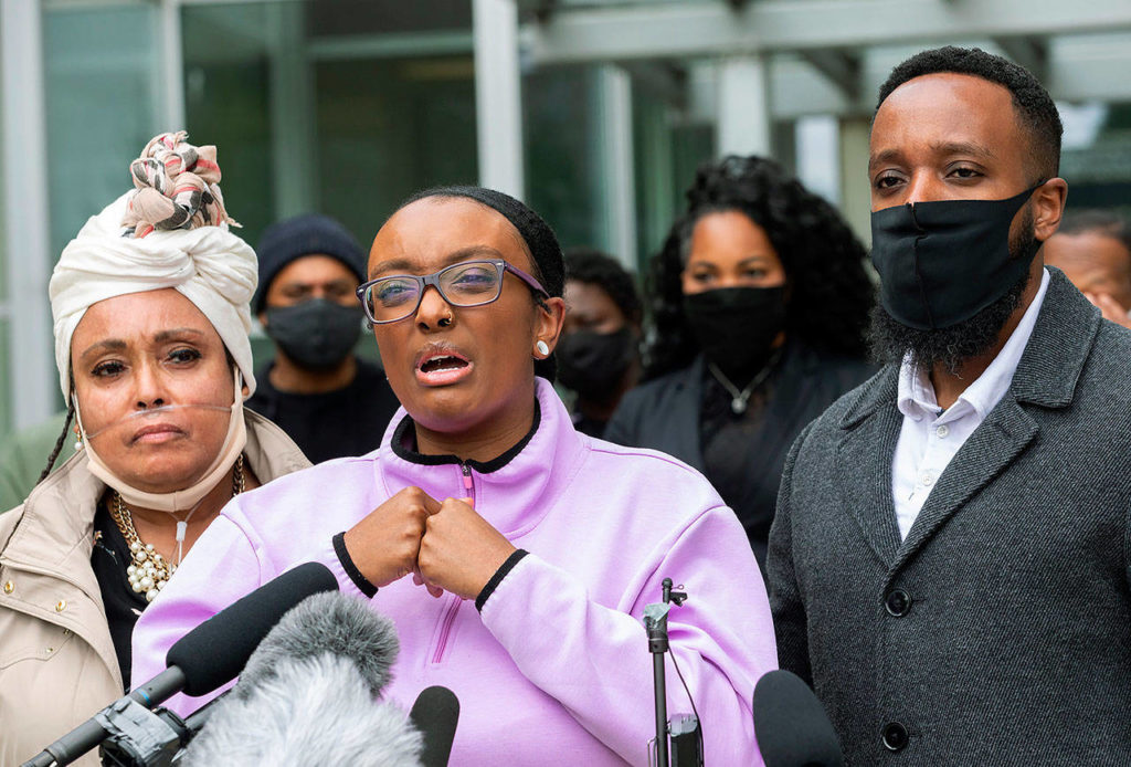 Monet Carter-Mixon (center), the sister of Manuel Ellis, speaks at a press conference June 4, 2020, as Ellis’ mother, Marcia Carter-Patterson (left), and brother Matthew Ellis (right) look on. (Ellen M. Banner/The Seattle Times via AP, file)
