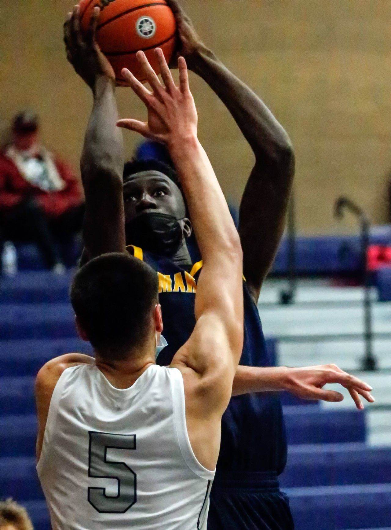 Mariner’s BJ Kolly attempts a shot over Glacier Peak’s Tucker Molina during the third quarter of a game Thursday evening at Glacier Peak High School in Snohomish. Mariner won 64-36. (Kevin Clark / The Herald)