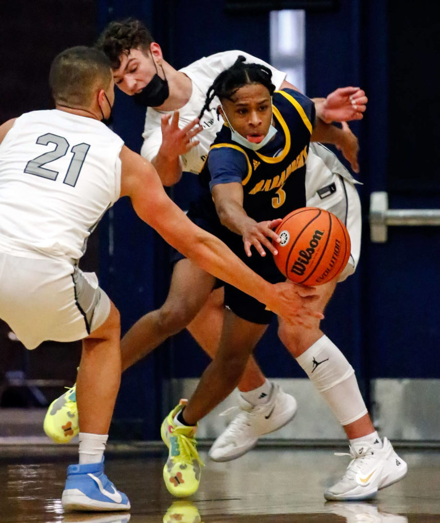 Mariner’s Jailin Johnson (right) chases down a loose ball through Glacier Peak’s defense during a game Thursday evening at Glacier Peak High School in Snohomish. Mariner won 64-36. (Kevin Clark / The Herald)
