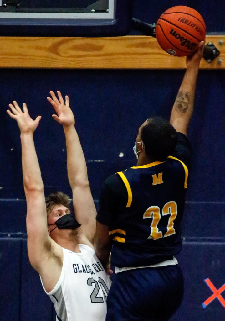 Mariner’s Naser Motley (right) attempts a shot with Glacier Peak’s Tyson Willis defending during a game Thursday evening at Glacier Peak High School in Snohomish. Mariner won 64-36. (Kevin Clark / The Herald)
