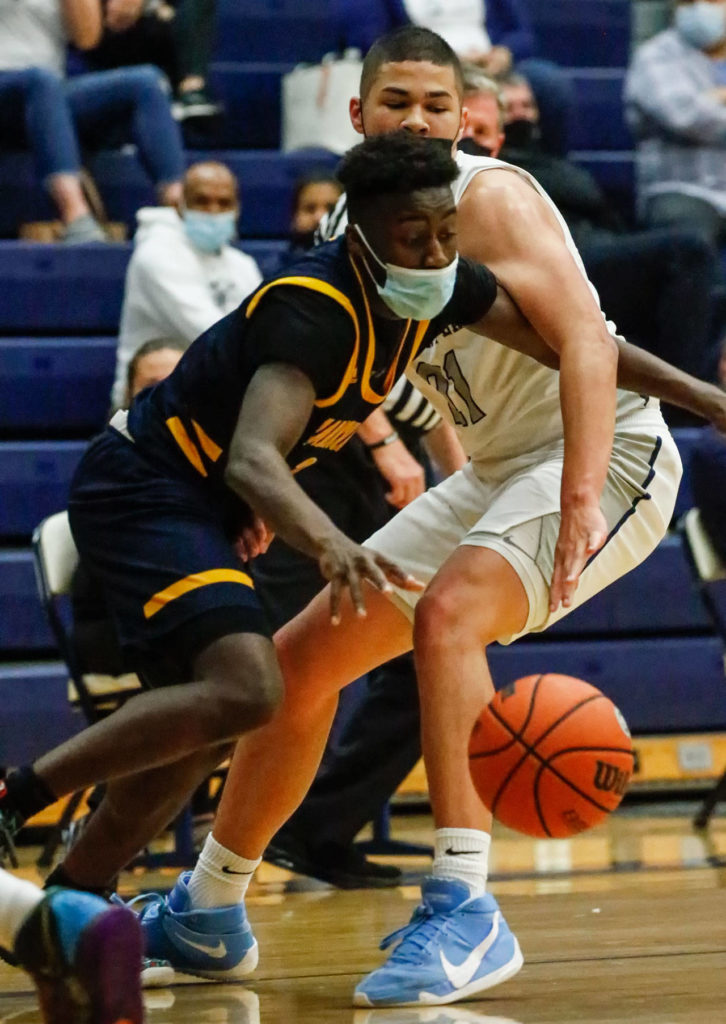 Mariner’s Tijan Saine (left) controls the ball with Glacier Peak’s Torey Watkins defending during a game Thursday evening at Glacier Peak High School in Snohomish. Mariner won 64-36. (Kevin Clark / The Herald)
