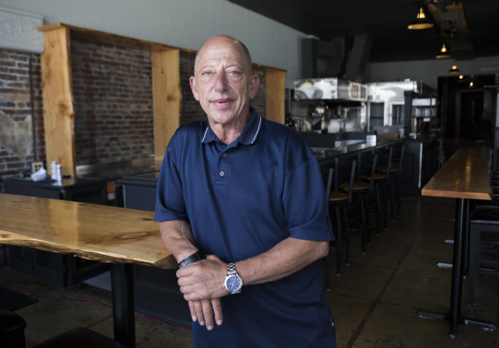 Joel Starr, owner of the Flying Pig, stands in the new restaurant space that was formerly the Prohibition Grille/Gastropub and most recently Abbott’s at 1414 Hewitt Ave. in Everett. The Flying Pig 2.0, a reboot of a previous pub he started by that name in 1997, is slated to open in mid-July. (Olivia Vanni / The Herald)
