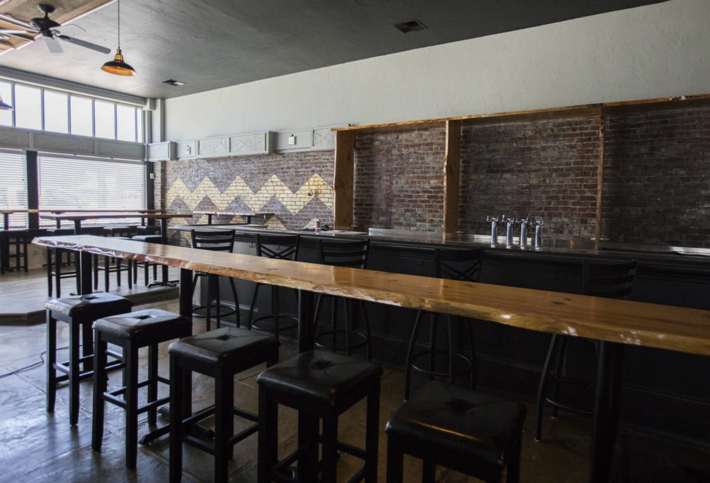 Wooden bar tops and custom bar shelves inside the new Flying Pig in Everett. (Olivia Vanni / The Herald)

