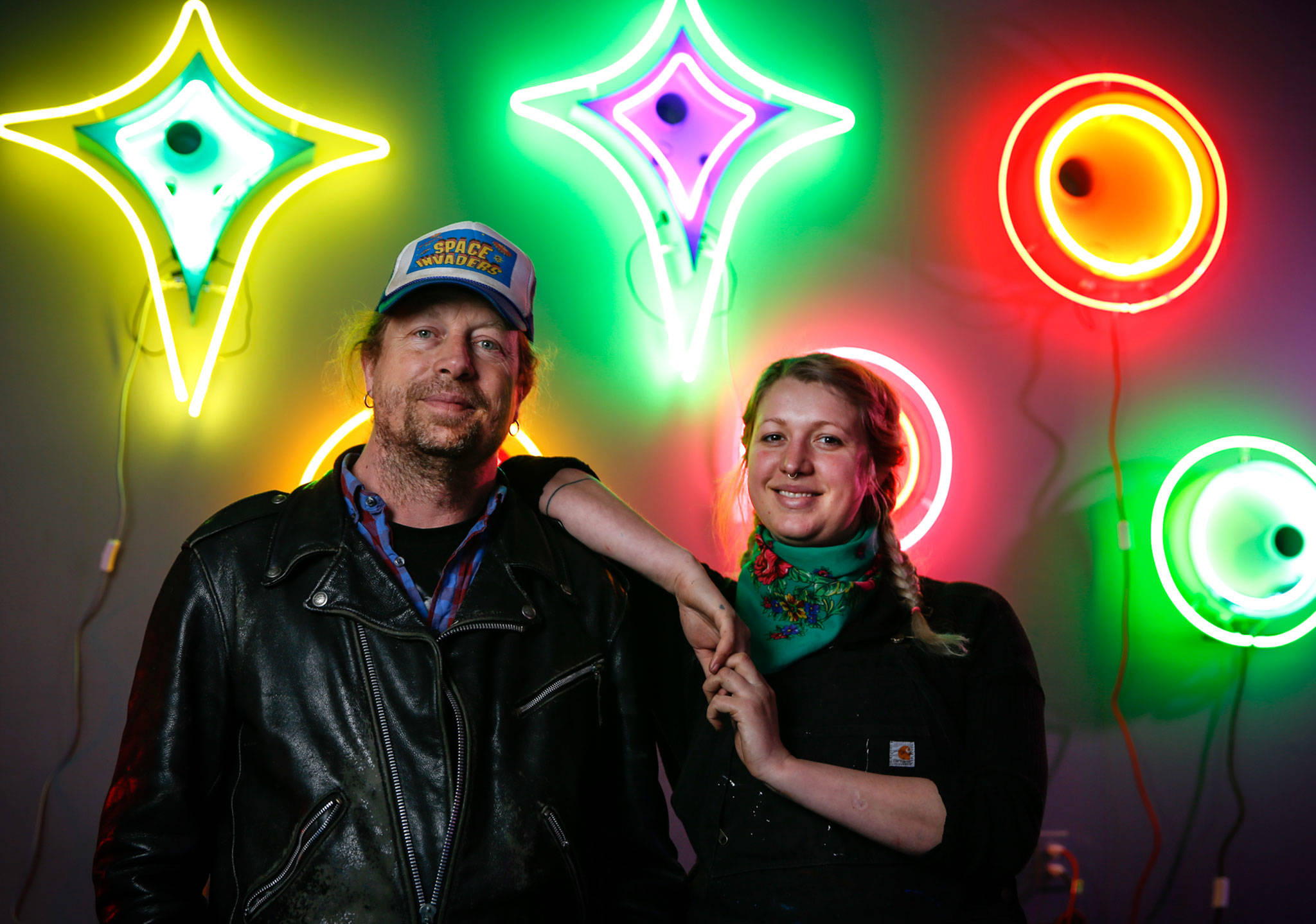 Neon artist Tim Leonard (left), owner of The Machine Shop arcade in Langley, spent much of the pandemic making art pieces and teaching the craft to his daughter Sage Leonard. The neon art is on display at the arcade through June. (Kevin Clark / The Herald)