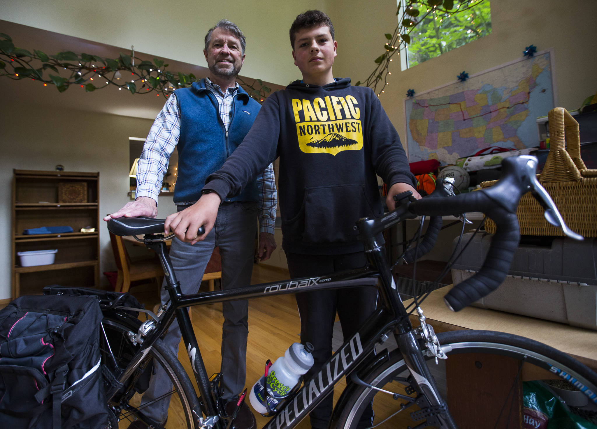 Jon Boyce (left) and his grandson, Deven Boyce, 14, in their home in Mukilteo before leaving on a two-month bike trip across the country. (Olivia Vanni / The Herald)