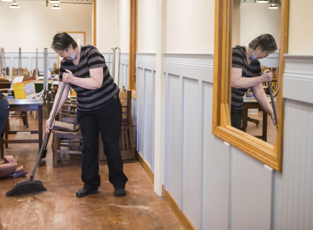 Victoria Quall sweeps the floors inside The Sisters Restaurant in Everett. (Olivia Vanni / The Herald)
