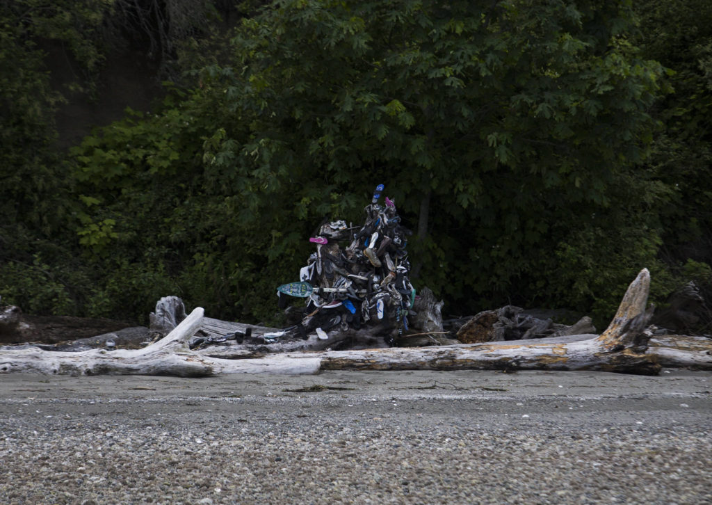 A stump on Hat Island displays items that have washed up on shore in Possession Sound. Volunteers check the stump regularly for Cortez’s boots and other items. (Olivia Vanni / The Herald)
