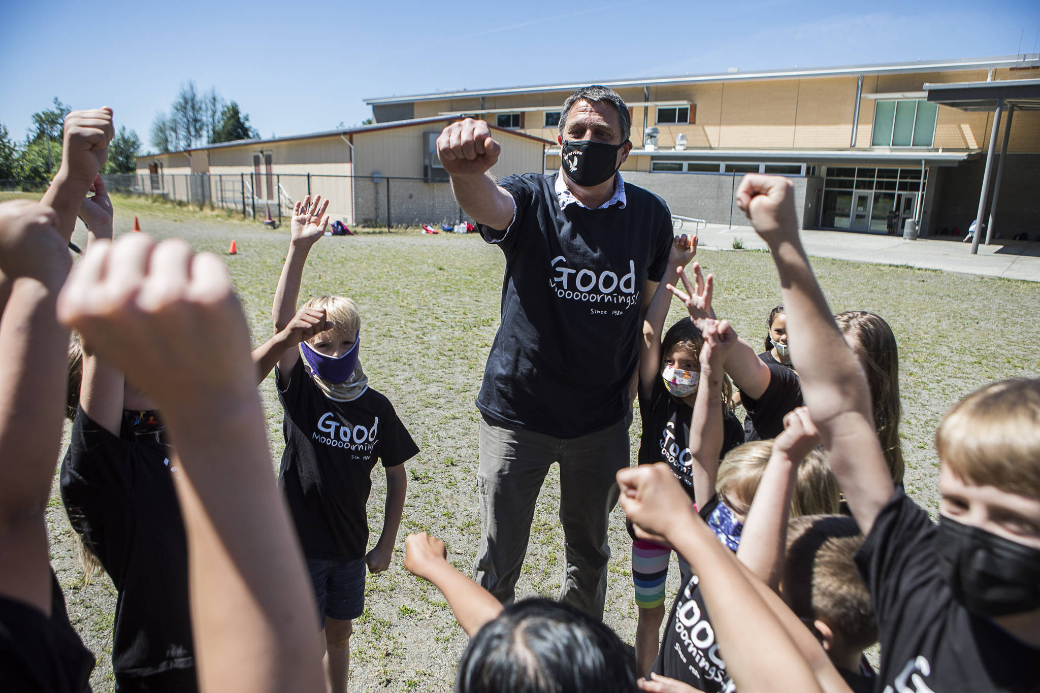 Jeff Thoreson does a cheer with his second-grade class before the start of their kickball game on his last in-person day of school Thursday in Snohomish. (Olivia Vanni / The Herald)