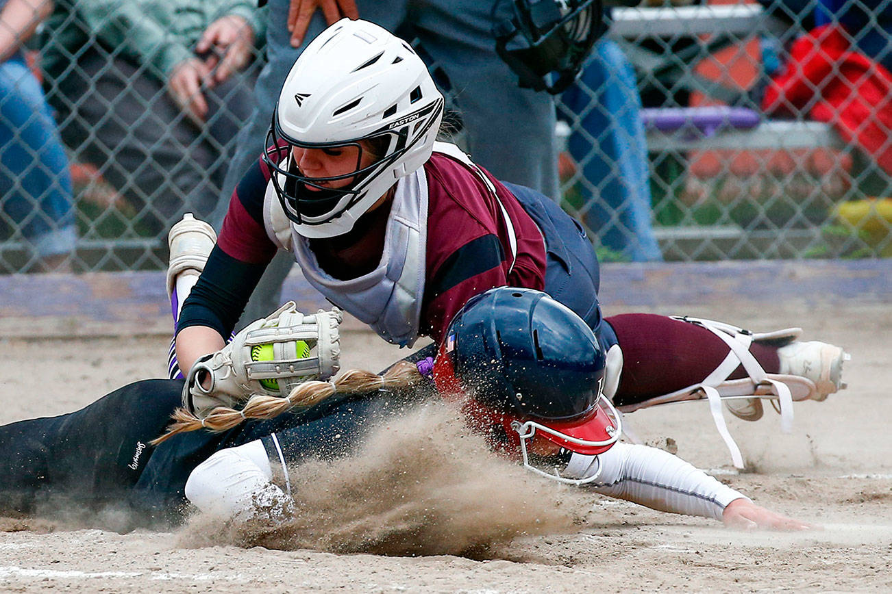 Lakewood's Ashtyn Falor tags out Jayden Bushnell Friday afternoon at Kamiak High School in Mukilteo on April 30, 2021. The Knights won 2-0. (Kevin Clark / The Herald)