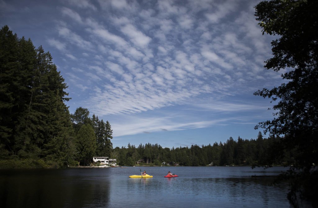 Lily Stewart and Gemma Rommel paddle around Crabapple Lake. (Olivia Vanni / The Herald)
