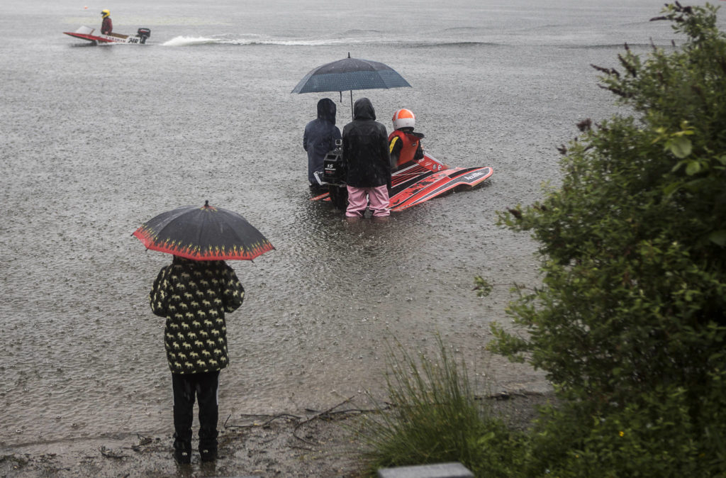 Racers wait in the rain as people make their way into the pits during the on Saturday, June 5, 2021 in Everett, Wash. (Olivia Vanni / The Herald)
