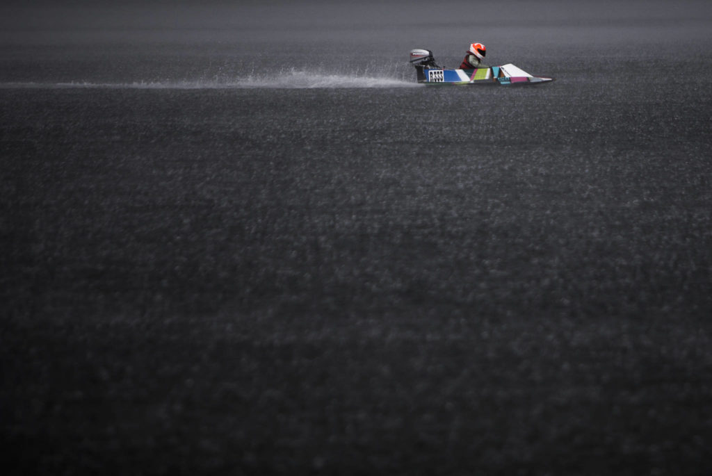 Kannon Cushing races his mini hydroplane through a rainstorm during the Seattle Outboard Association’s Silver Lake Regatta on Saturday, June 5, 2021 in Everett, Wash. (Olivia Vanni / The Herald)
