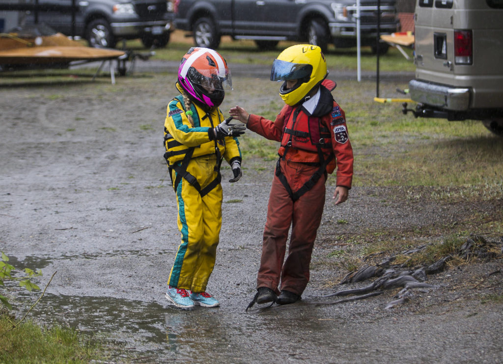 Harper Kelly-Moen and Carson Kelly high five after their races during the Silver Lake Regatta on Saturday, June 5, 2021 in Everett, Wash. (Olivia Vanni / The Herald)
