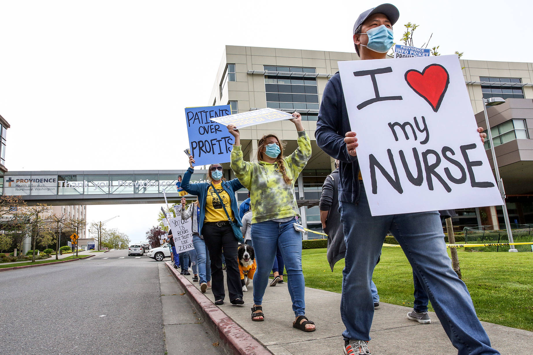 Supporters march Wednesday afternoon across from Providence Medical Center in Everett on May 5, 2021. (Kevin Clark / The Herald)