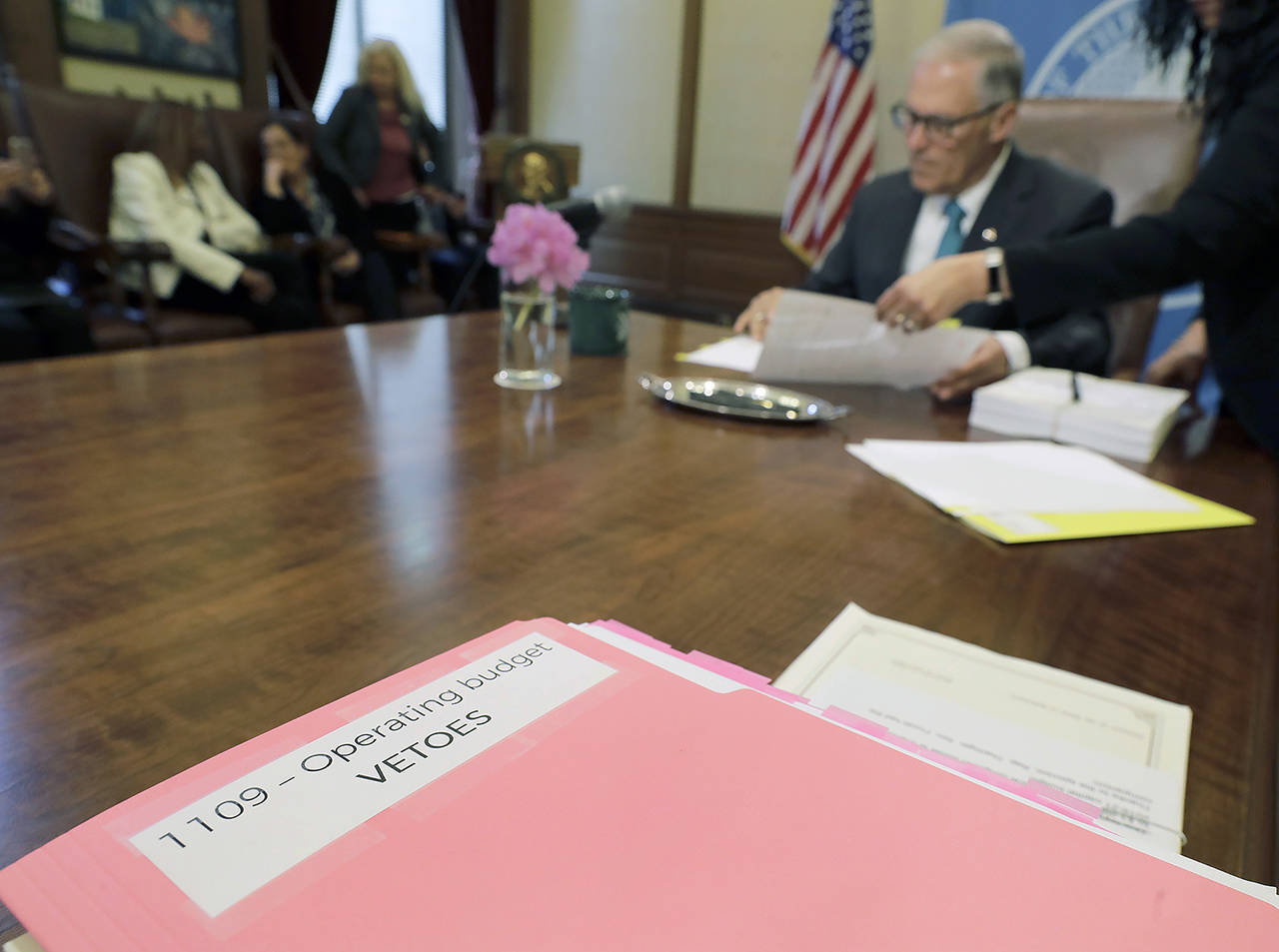 Washington Gov. Jay Inslee uses a red pen to veto sections of the state capital budget, May 21, 2019, at the Capitol in Olympia. (AP Photo/Ted S. Warren, file)