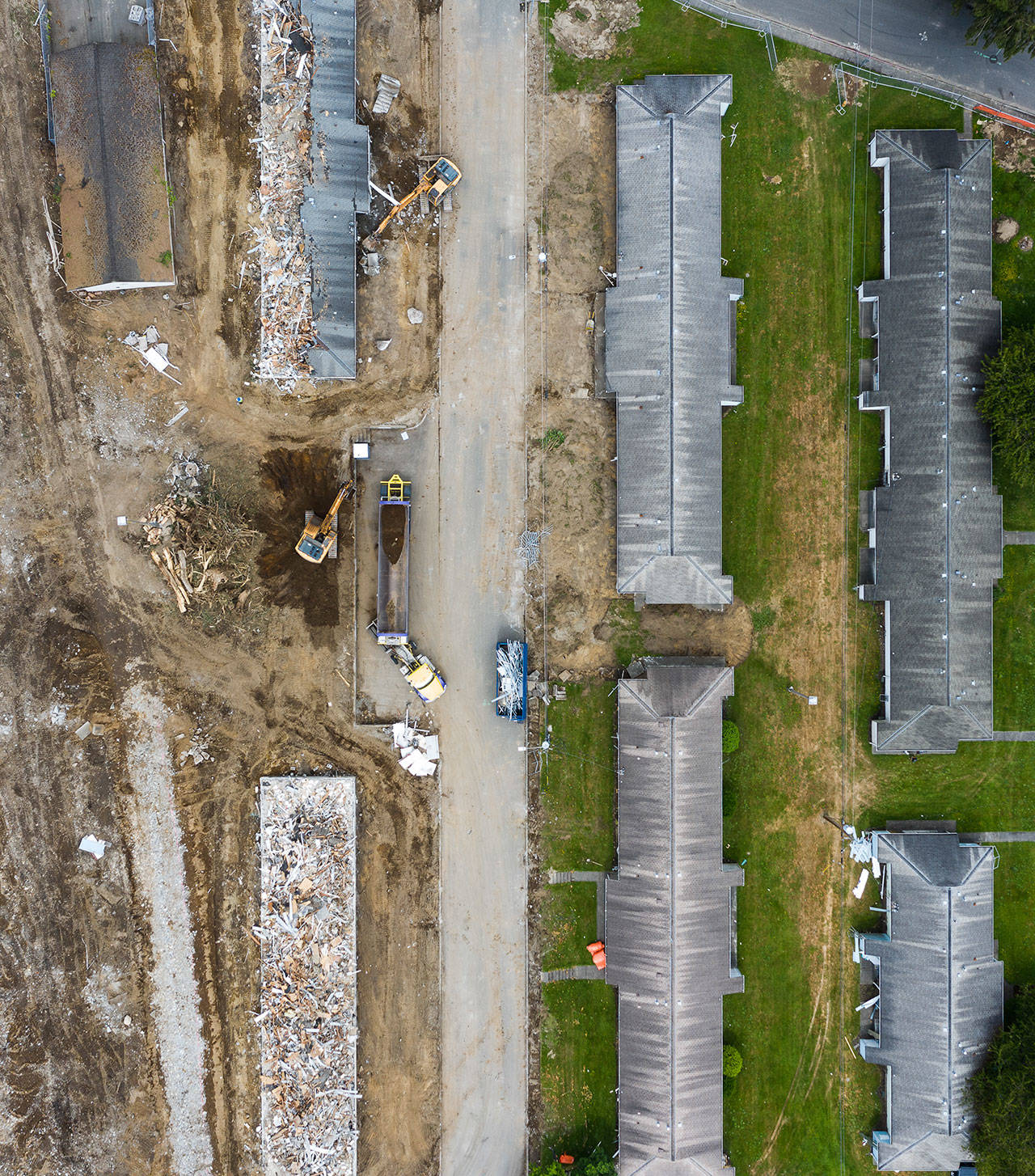 Construction crews demolish public housing at Baker Heights in Everett’s Delta neighborhood on Tuesday. (Chuck Taylor / The Herald)