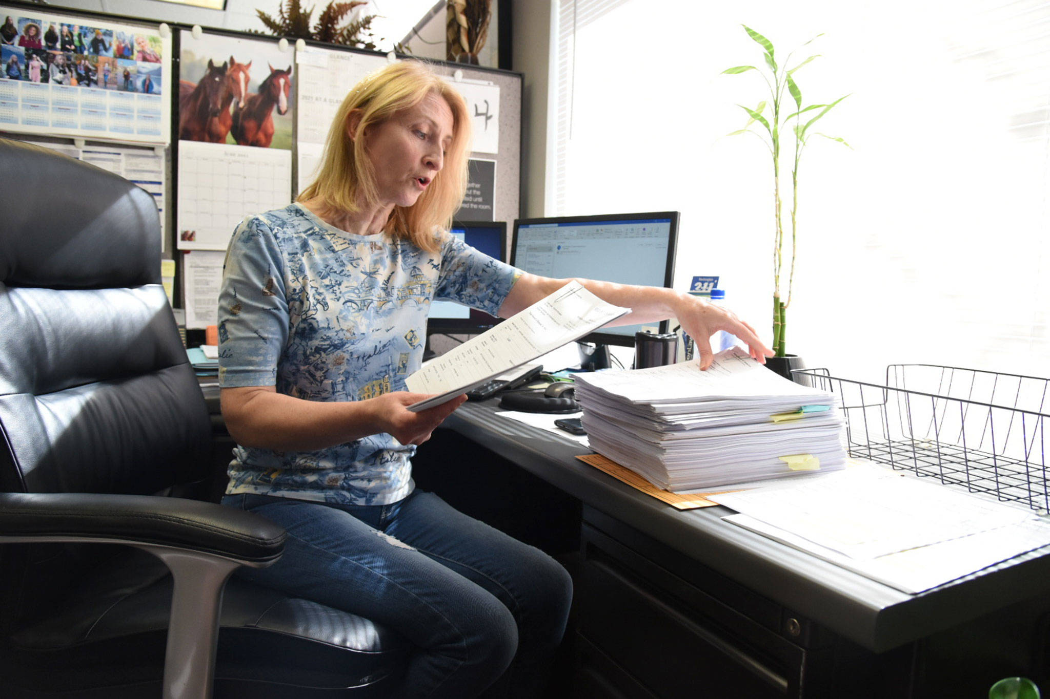 Galina Volchkova, the Volunteers of America housing director, discusses the volume of applications for rental assistance her office received on Friday. (Katie Hayes / The Herald)