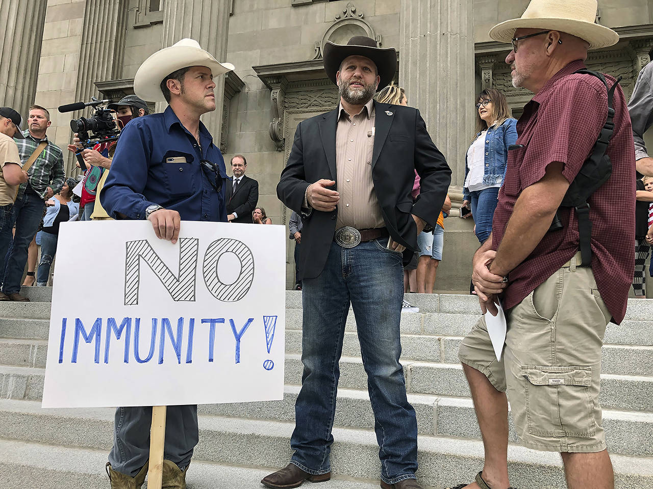 In this August 2020 photo, Ammon Bundy (center), who led the Malheur National Wildlife Refuge occupation, stands on the Idaho Statehouse steps in Boise, Idaho. (AP Photo/Keith Ridler, File)