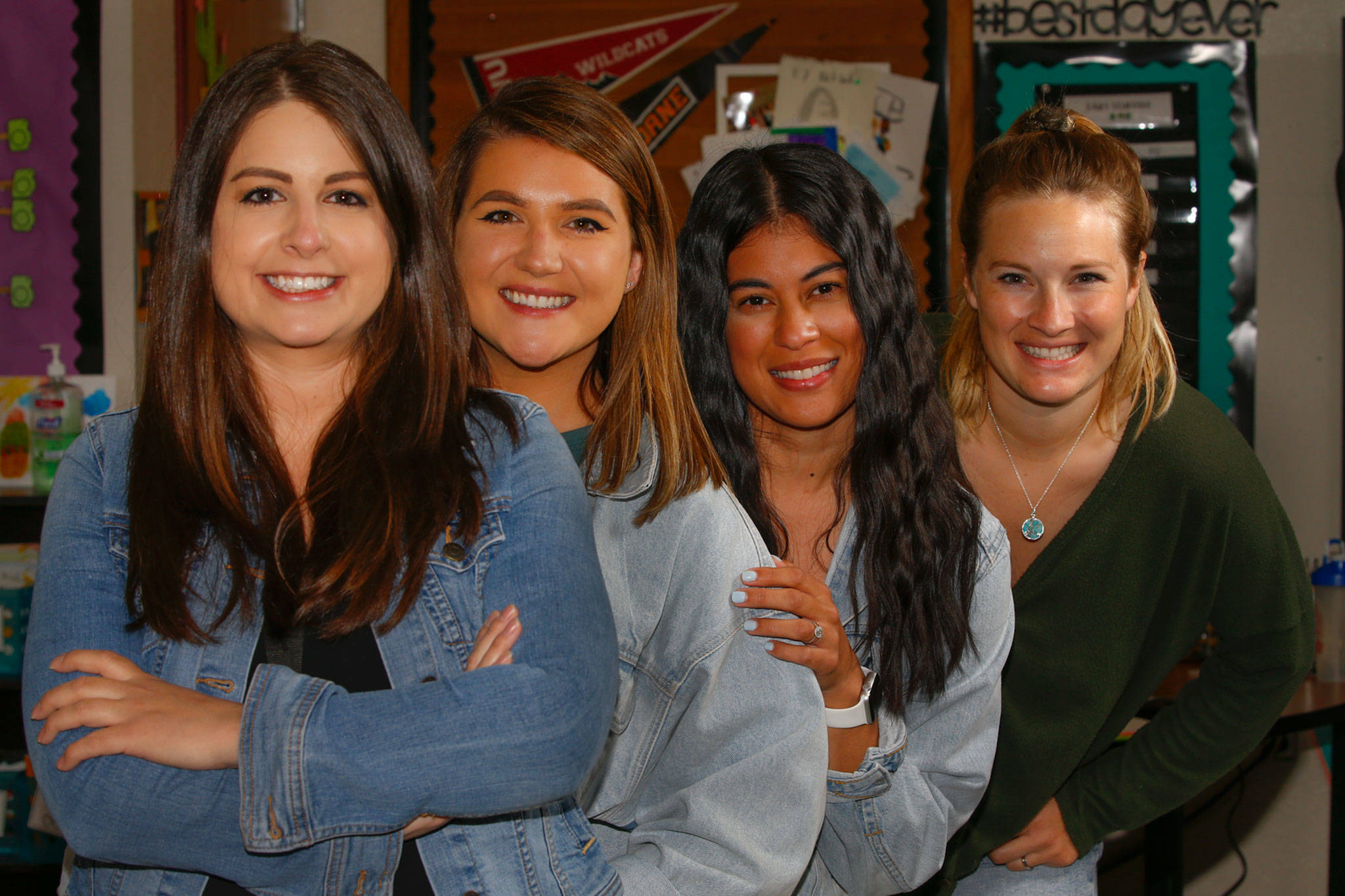 From left, Taleah Burr , Laurel Harrison, Caitlin Hitchner and Kelsey Jinneman-Fairbanks are teachers at Challenger Elementary School in Everett who each got a Roman numeral IV tattoo to represent their “Core IV” team solidarity after their first year teaching in 2014-15. (Kevin Clark / The Herald)