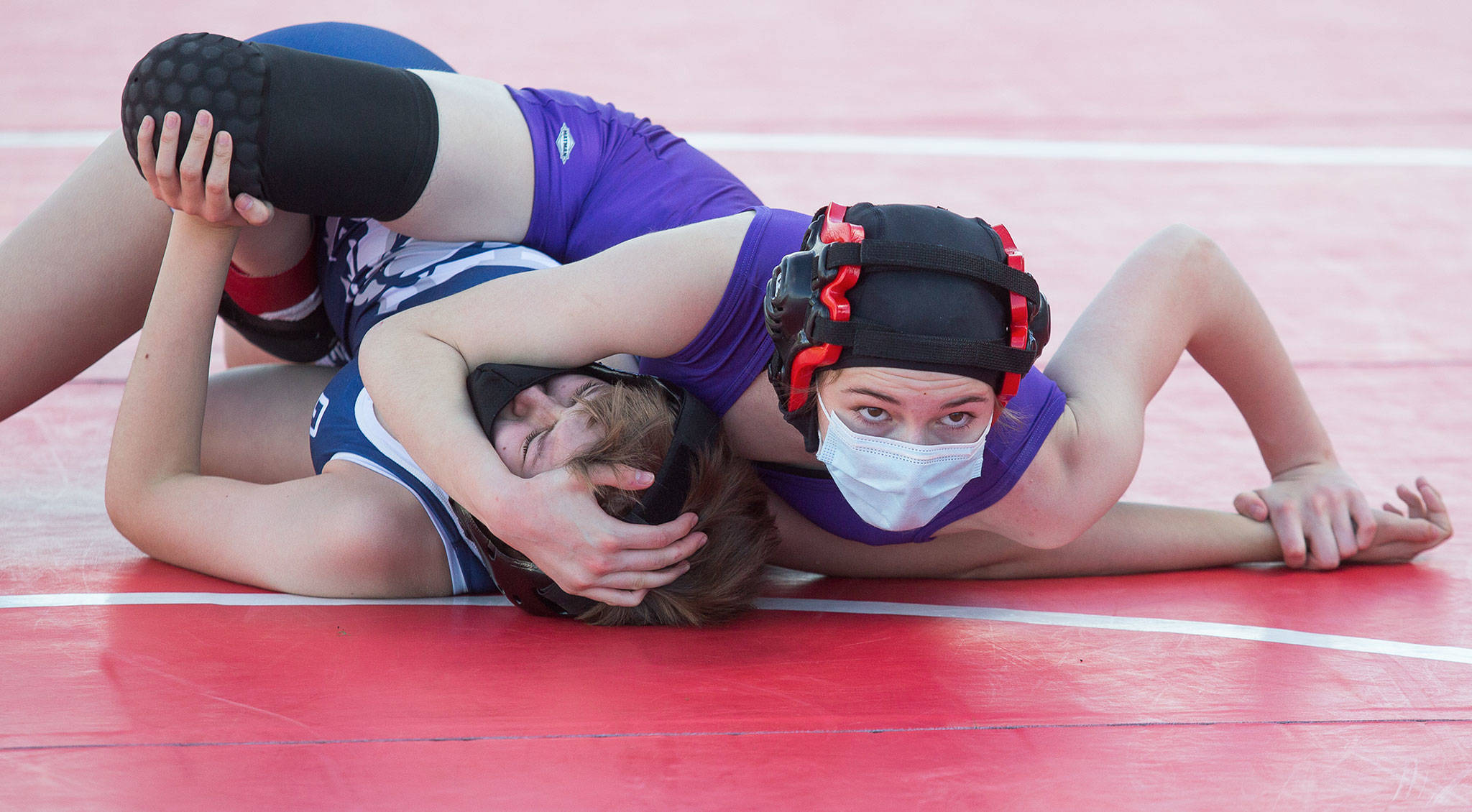 Lake Stevens’ Mikaela Miller (top) looks at the clock as she pins Glacier Peak’s Lillian Germer during a girls wrestling scramble held outside at Marysville Pilchuck High School on Tuesday in Marysville. (Andy Bronson / The Herald)