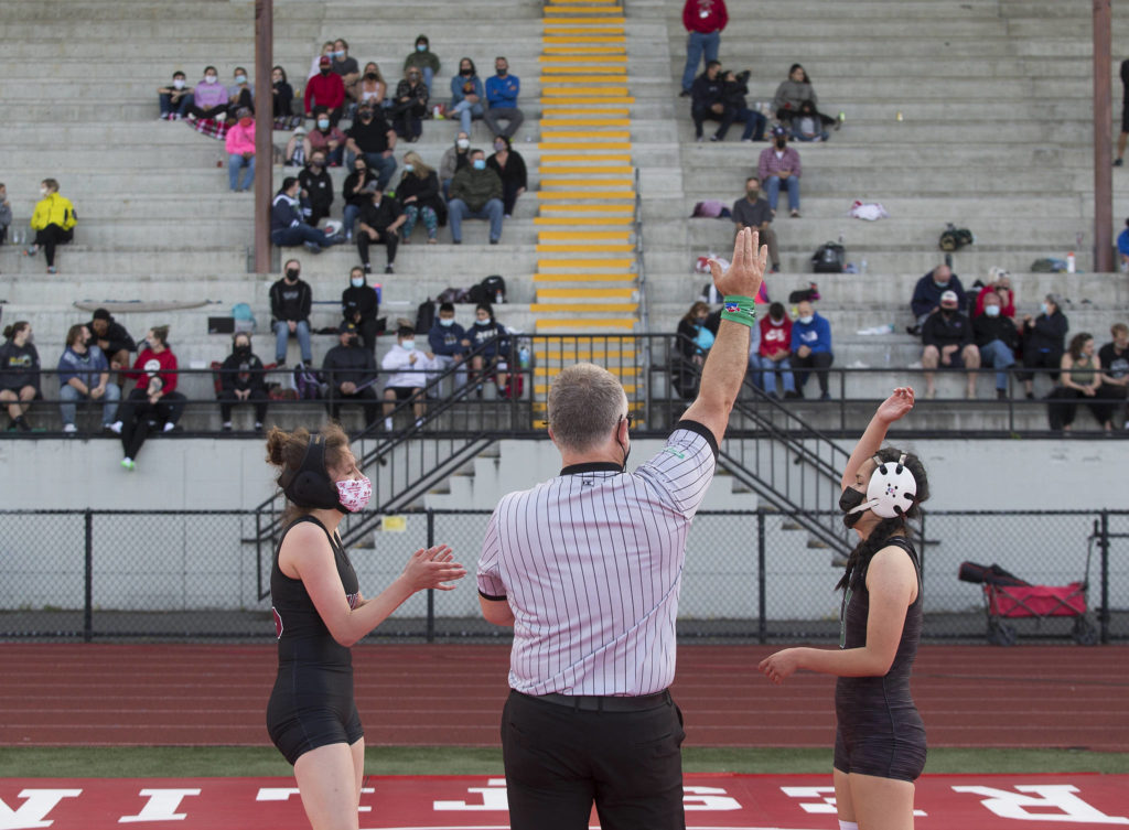 Marysville Pilchuck’s Emily Heck claps as Jackson’s Jocelyn Villa is announced as the winner of their match at a girls wrestling scramble held outside at Marysville Pilchuck High School on Tuesday in Marysville. (Andy Bronson / The Herald)
