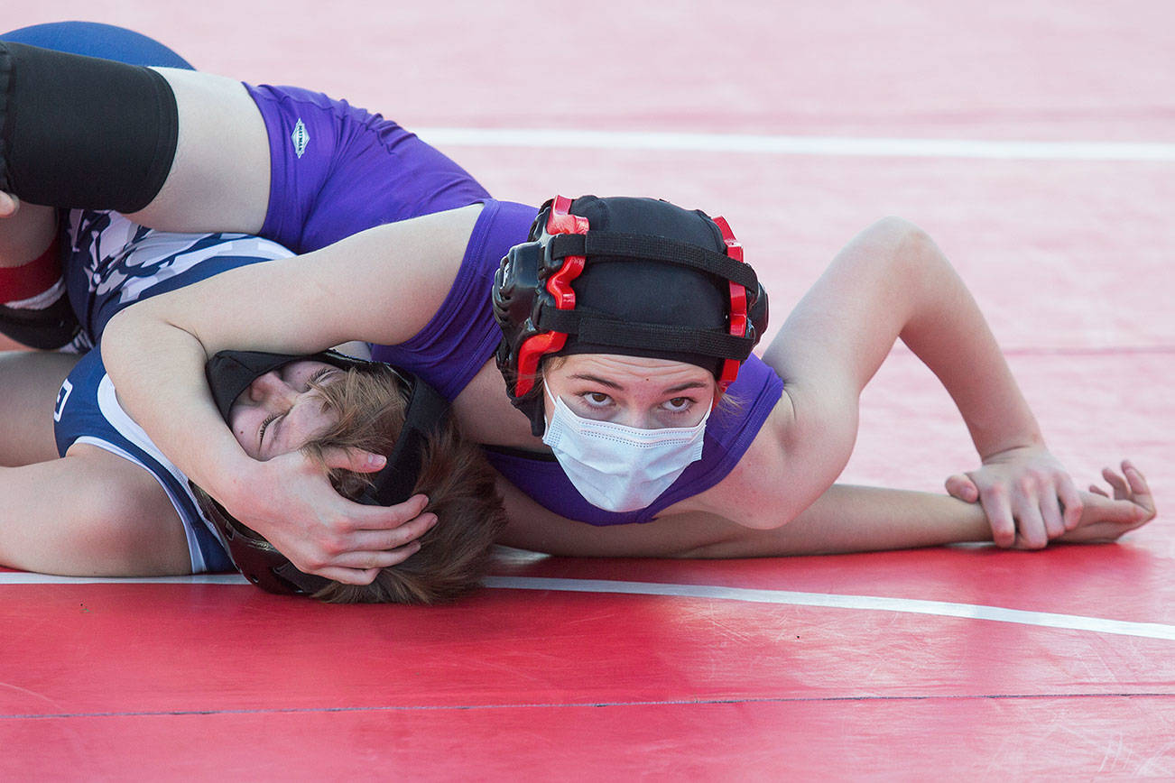 Lake Stevens' Mikaela Miller looks at the clock as she pins Glacier Peak's Lillian Germer at a girls' wrestling scramble held outside at Marysville Pilchuck High on Tuesday, June 8, 2021 in Marysville, Washington.  (Andy Bronson / The Herald)